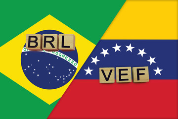 Brazil and Venezuela currencies codes on national flags background