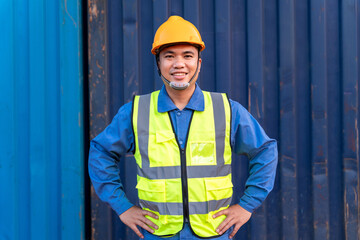 Portrait of Asian workers import and export goods wear a helmet logitics shipping at container background.