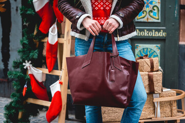 stylish woman on a sidewalk, urban street style, winter fashion trend, legs close up, accessories, cherry colour bag