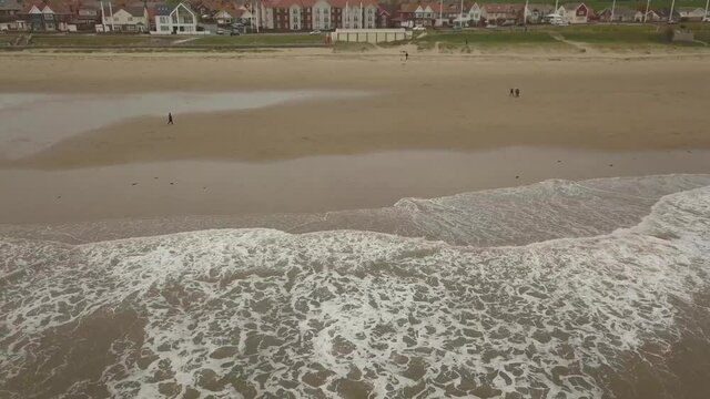 Aerial drone footage of waves crashing onto the beach, Seaburn Beach, Sunderland.