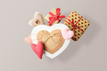 Valentine's day concept with heart shapes and gift boxes levitating over gray background