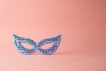 Carnival mask over pink background. Creative minimal concept