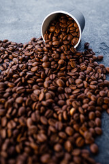 Coffee beans in a paper cup.