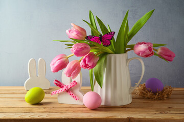Easter holiday concept with easter eggs and tulip flowers on wooden table