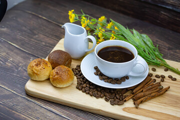 coffee and bread with coffee bean on wood