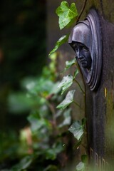 sad looking face on tombstone