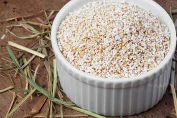 Old wooden table with a portion of puffed Amaranth as detailed close-up shot (selective focus)