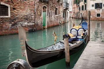 Fototapeta na wymiar Gondola tied to a boardwalk, Venice, Italy