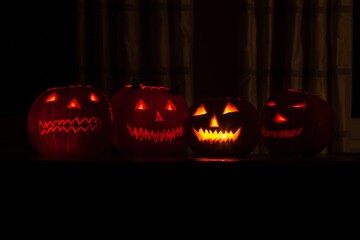 dimly lit jack o lanterns with candles