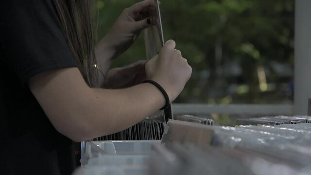 Girl searching in cd box