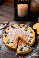 Whole lemon cake as in christmas atmosphere with candles and snow around, catalogue photo