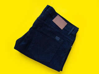 Black long jeans See the details of the fabric Put on a yellow background