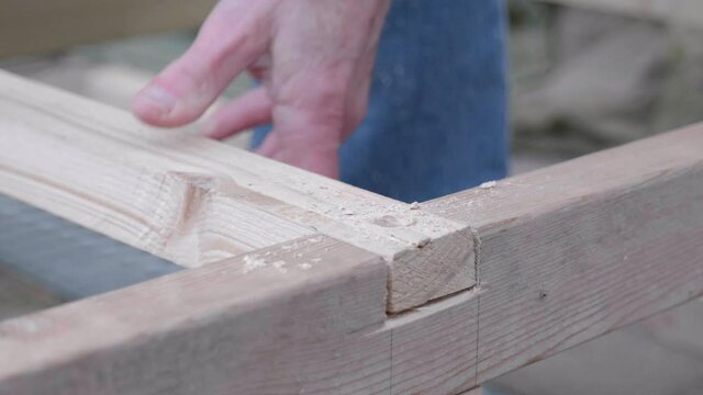 A man countersinking some wood.