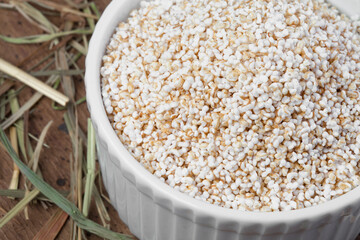 Old wooden table with a portion of puffed Amaranth as detailed close-up shot (selective focus)