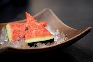 Close up of sliced watermelon on ice served after finished eating