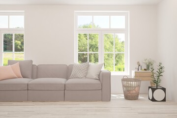 White living room with sofa and summer landscape in window. Scandinavian interior design. 3D illustration