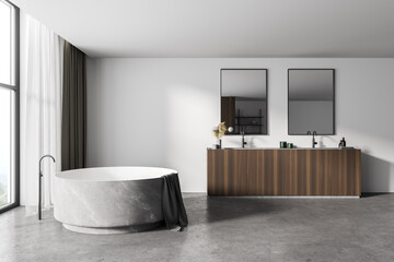 White bathroom interior with round tub and sink