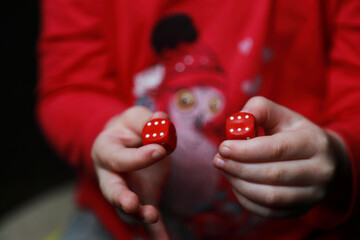 
dice in the hands of a child