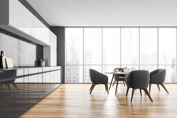 Black and white kitchen with table and four chairs near window