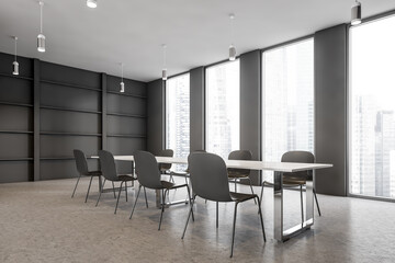 Black conference room with windows, black chairs and table