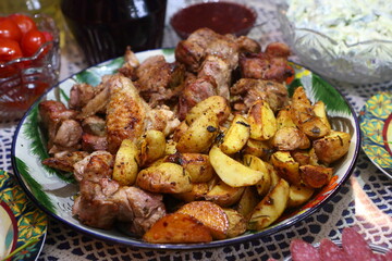 Kebab with potatoes on a plate