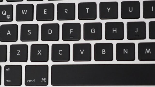 Pressing keys on a laptop keyboard - Close up