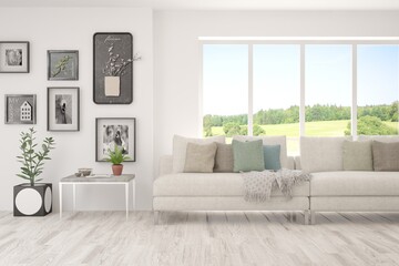 White living room with sofa and summer landscape in window. Scandinavian interior design. 3D illustration