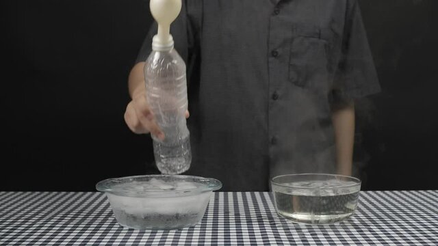 Science Education, Students test vapor expansion in balloon comparision between Hot water and Cool water