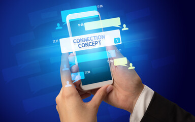 Female hand typing on smartphone with CONNECTION CONCEPT inscription, social networking concept