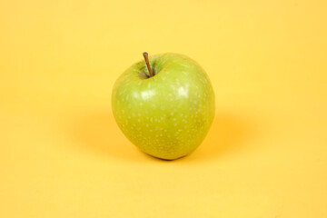 Shiny fresh apples. From the side view. The concept of placing fresh apples is combined with a yellow background, commonly used for design templates and mockups. Beautiful shape of an apple.