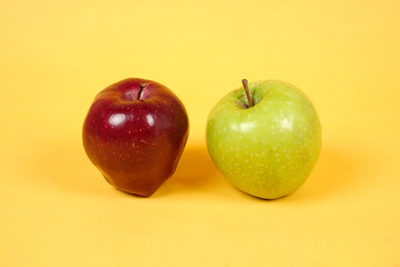 Shiny fresh apples. From the side view. The concept of placing fresh apples is combined with a yellow background, commonly used for design templates and mockups. Beautiful shape of an apple.