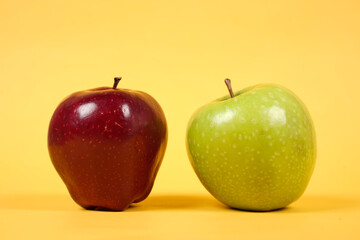 Shiny fresh apples. From the side view. The concept of placing fresh apples is combined with a yellow background, commonly used for design templates and mockups. Beautiful shape of an apple.