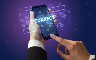 Female hand typing on smartphone with CONNECT inscription, social media concept