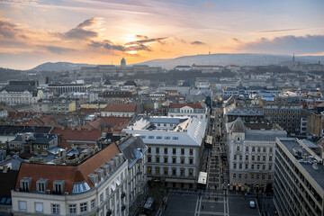 Fototapeta premium Budapest, Hungary - Panoramic view of Budapest from the colonade of St. Stephen's Basilica at sunset. View of the cathedral towers. Evening time.