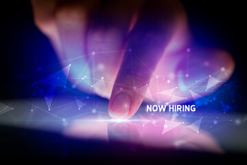 Finger touching tablet with NOW HIRING inscription, business concept