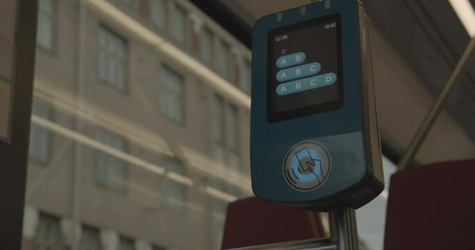 HSL Card and Visitor Card reader in Helsinki Tram. Contact less smart card electronic ticket validator. The tram leaves.