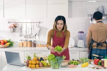 Asian man and woman couple family lover preparing and cooking healthy food with smile and happy emotion in modern kitchen room