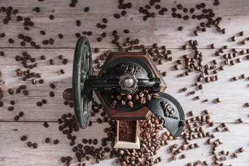 Vintage manual coffee grinder with coffee beans 