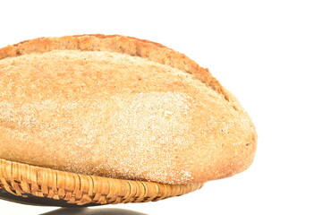 One fresh loaf without yeast with cereal in a ceramic bowl, close-up, isolated on white.