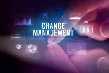 Finger touching tablet with charts and CHANGE MANAGEMENT inscription, business concept