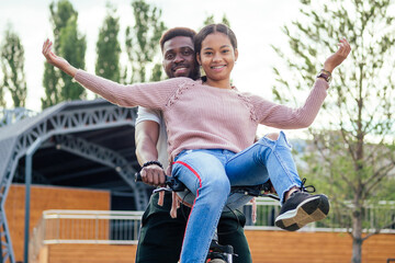 mixed race couple taking a cycle on rent phone app