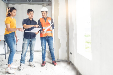 Young asian couple checking house with foreman engineering home inspection building house Walk home inspection with looking and pointing construction for check building home on job site to customers