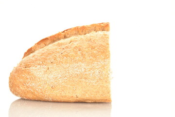 One half of a fragrant loaf without yeast with bran flakes, close-up, isolated on white.