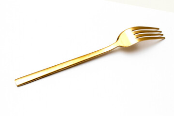 Top view of golden fork isolated white background.