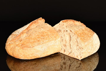 Two halves of a delicious loaf without yeast with bran cereal, close-up, isolated on black.