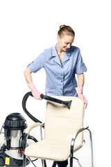 Young white woman in maid uniform is steam-cleaning an armchair isolated on a white background