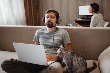 Couple Working And Playing With Laptop Computer At Home