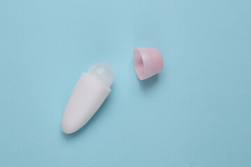 Antiperspirant roller on blue background. Top view