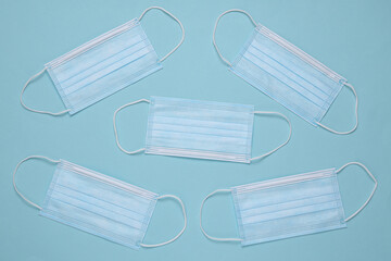 Medical facial masks on a blue background. Top view