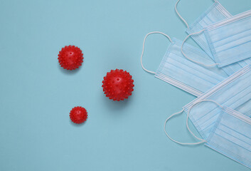 Medical masks and molecules of the virus strain on a blue background. Protection against bacteria